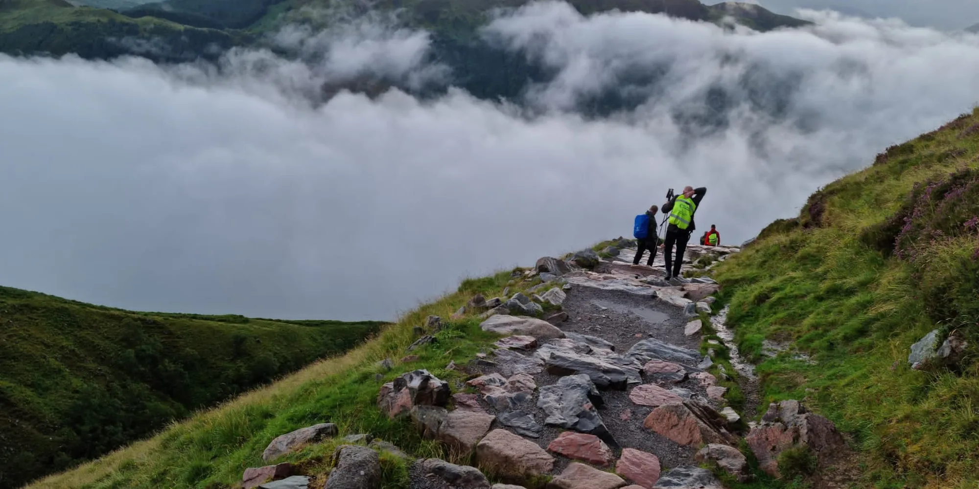 Challenge Central participants walking together through a mountain landscape